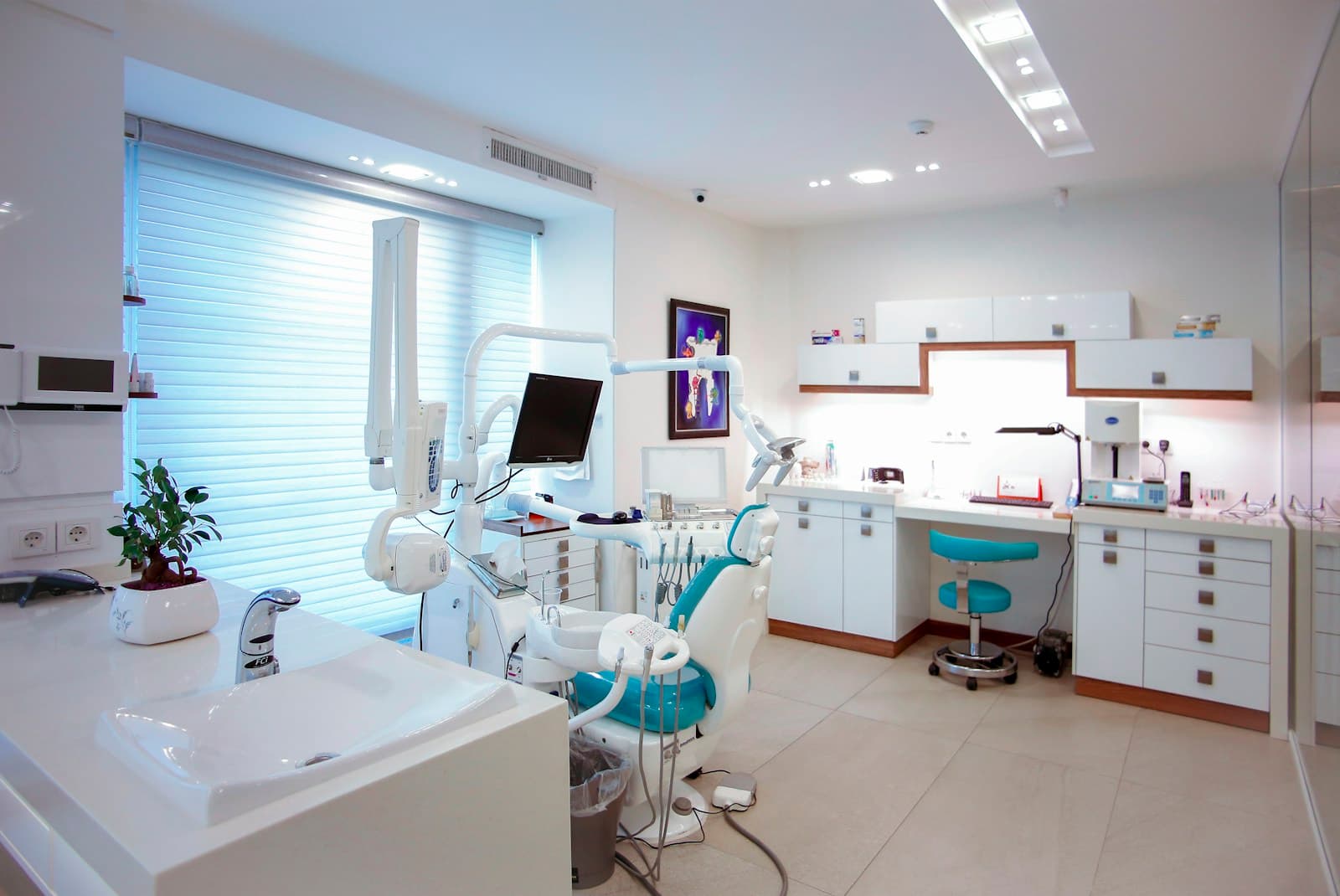 Modern dental treatment room with chair and clinical equipment